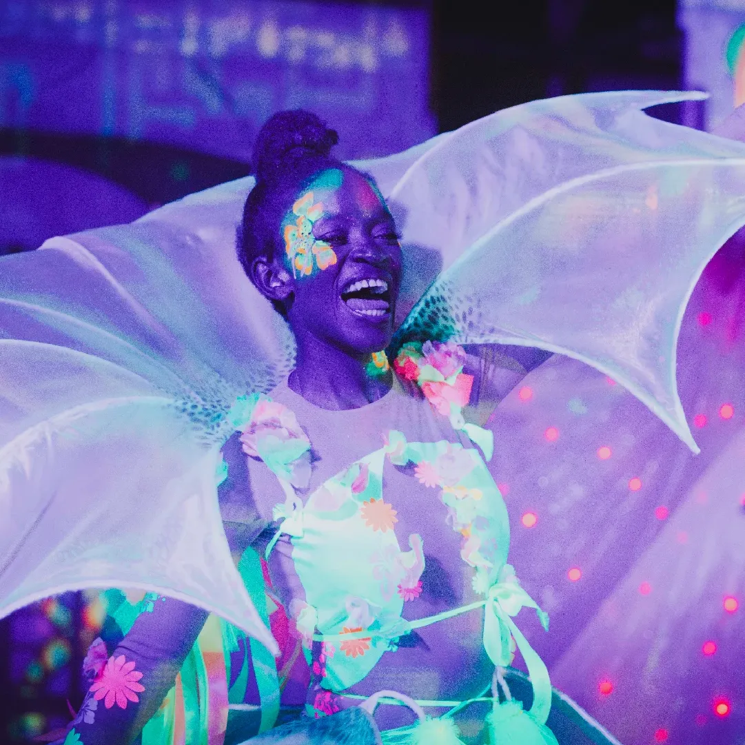 A photograph of a dancer in lumo at Alcazar NYE