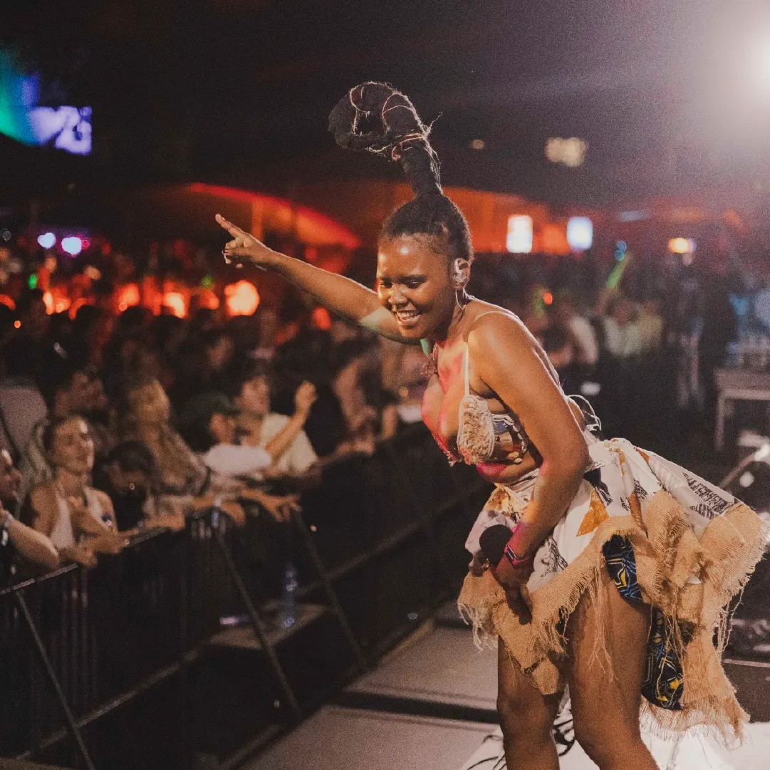 A photograph of a dancer at Alcazar NYE, pointing at the crowd.