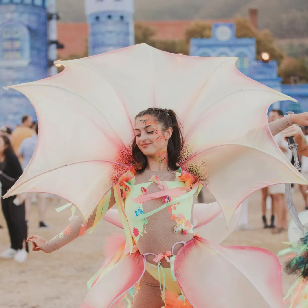 A photograph of a dancer during the day, wearing a big costume at Alcazar NYE