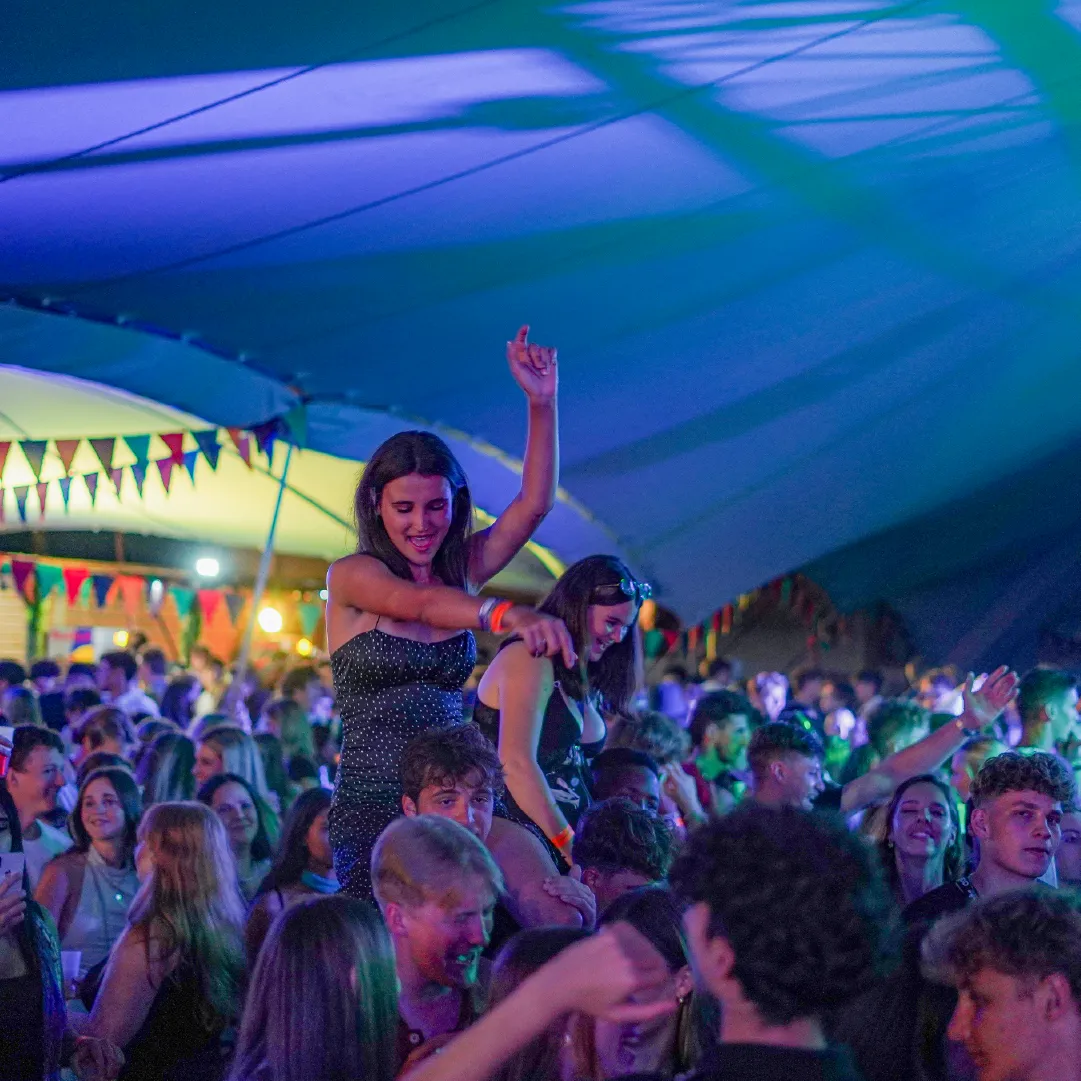 A photo of a aerobic performer on a suspended hoop, performing at a Sexy Groovy Love.
