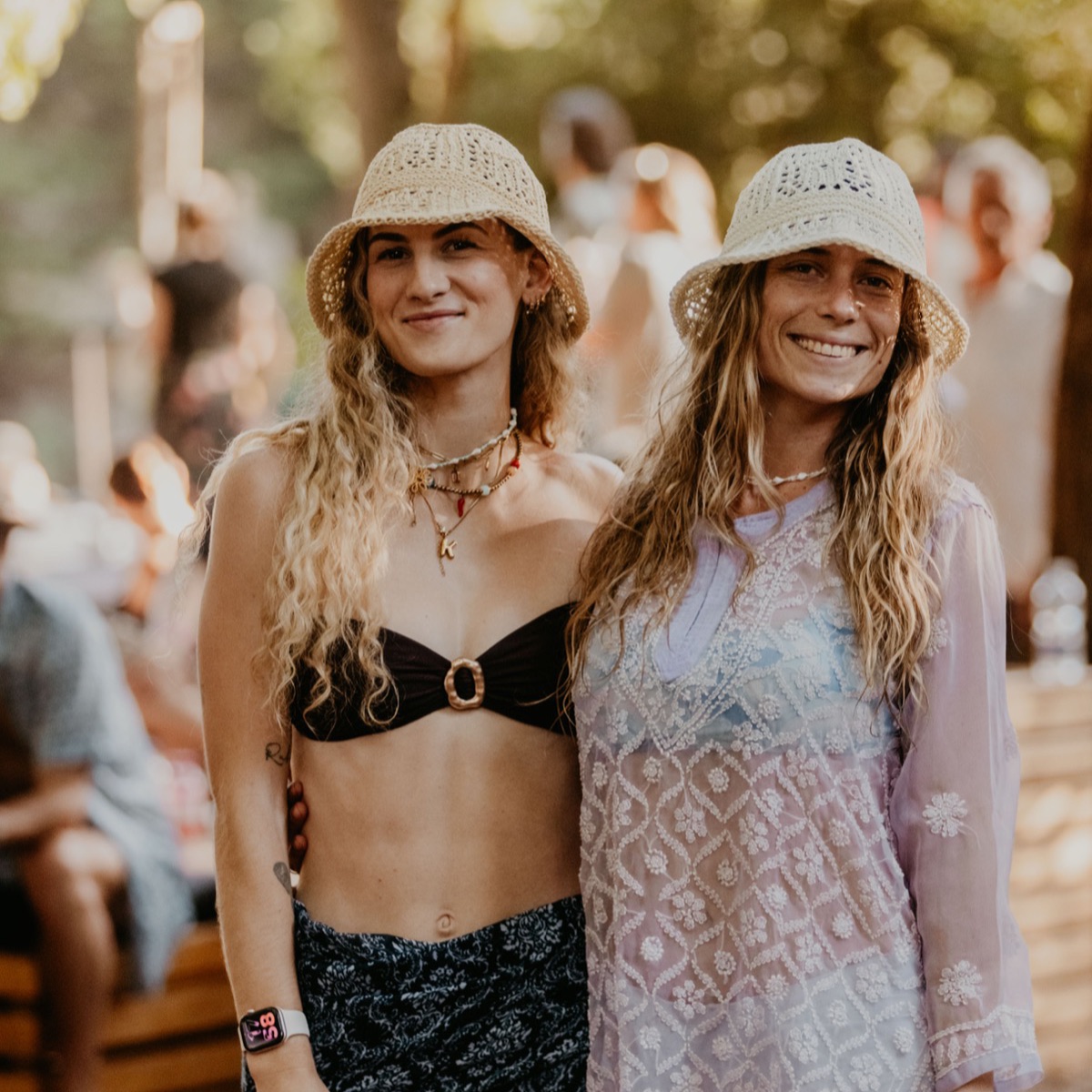 Two friends in bucket hats at a daytime party