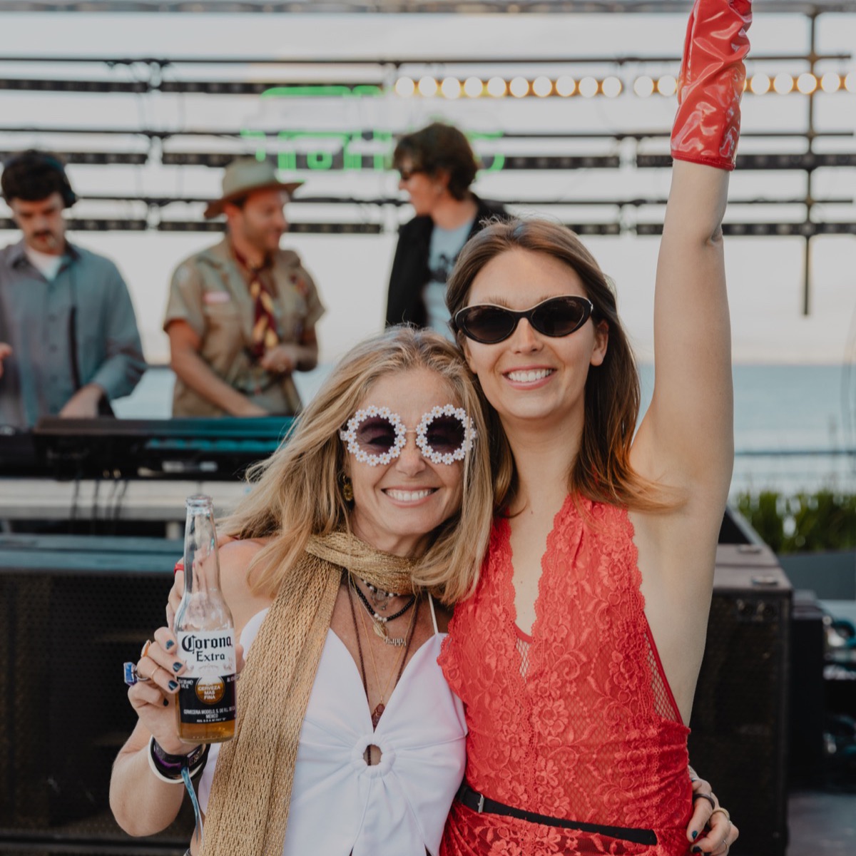 Two friends dancing beside the DJ booth