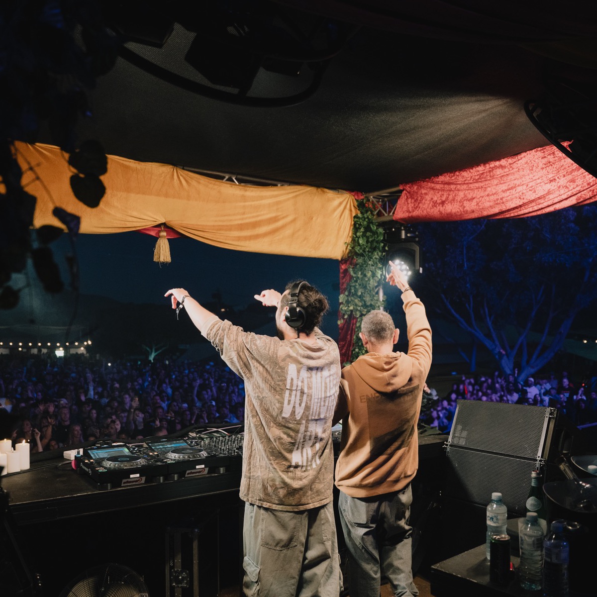 DJs playing to a large crowd from the stage