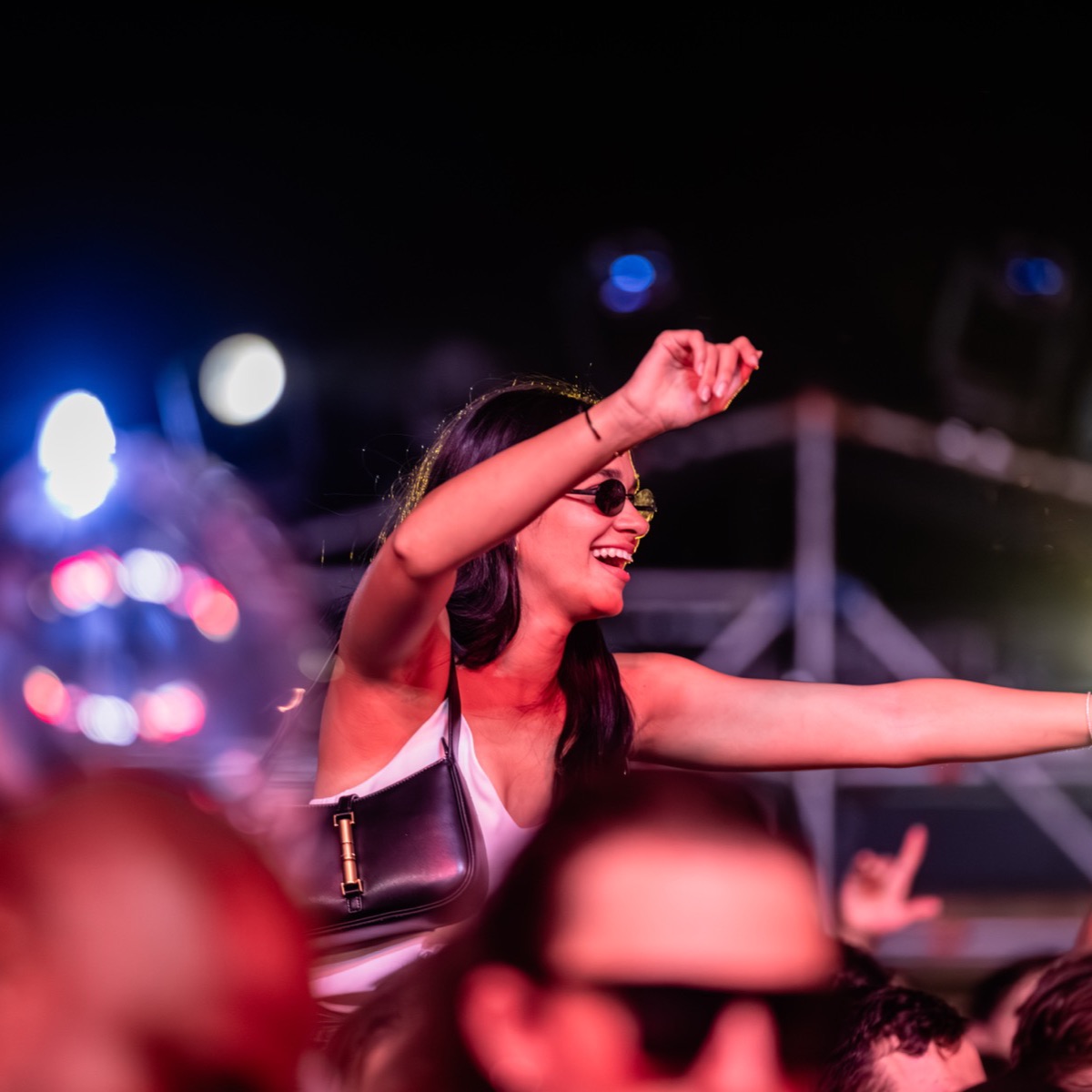 A dancer raised above the crowd at night