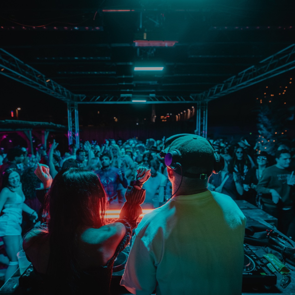 A packed dancefloor under blue stage lights