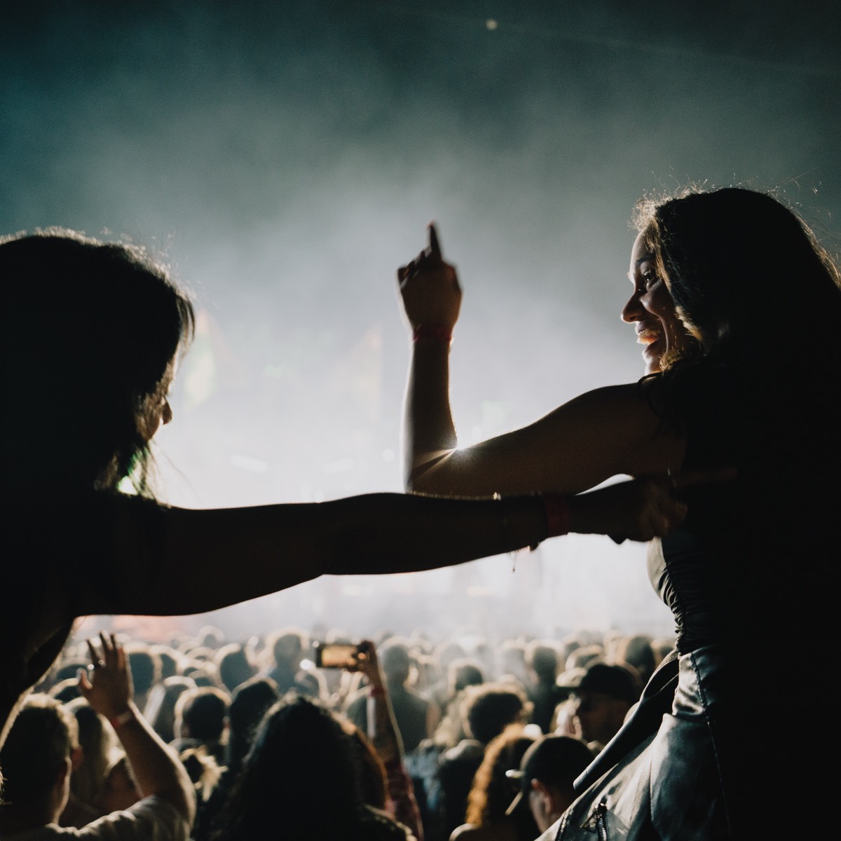 Silhouettes of dancers against the stage lights